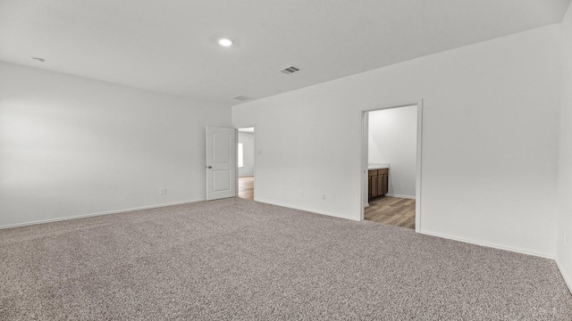 unfurnished room featuring recessed lighting, visible vents, light colored carpet, and baseboards