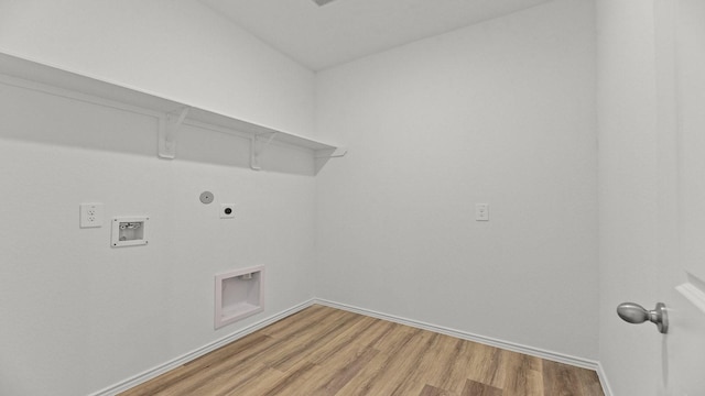 clothes washing area featuring baseboards, light wood-style floors, laundry area, electric dryer hookup, and hookup for a washing machine