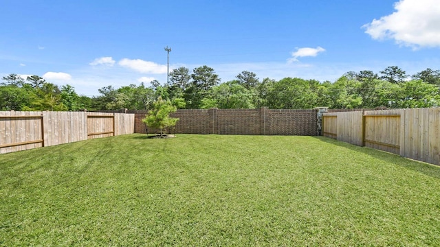 view of yard with a fenced backyard