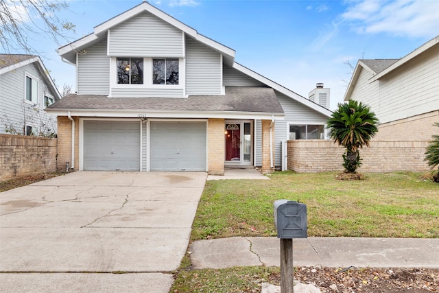 view of front of house featuring a garage and a front lawn