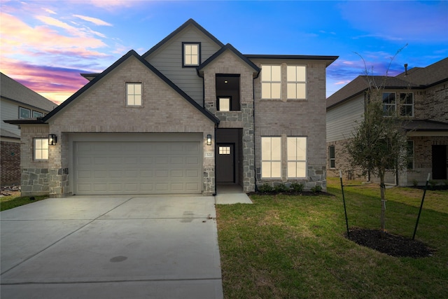 view of front of house with a yard and a garage