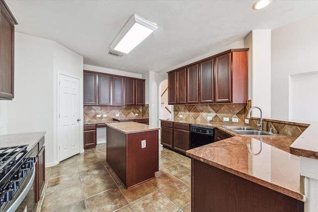 kitchen with backsplash, a center island, sink, black dishwasher, and stainless steel gas range