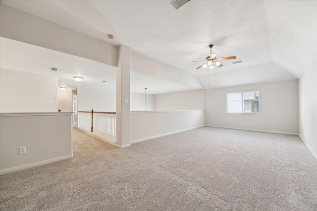 carpeted empty room featuring ceiling fan and lofted ceiling