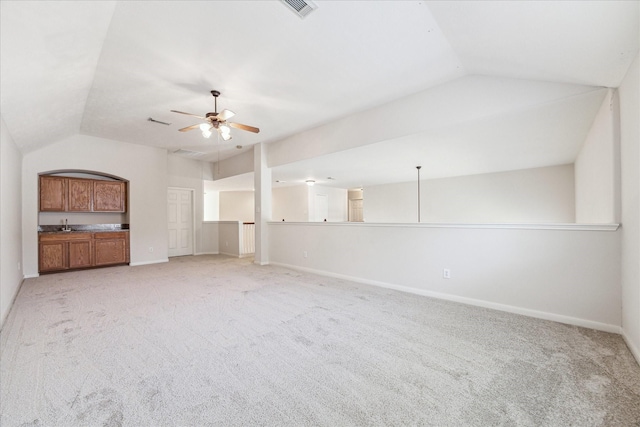 unfurnished living room with light carpet, vaulted ceiling, and ceiling fan