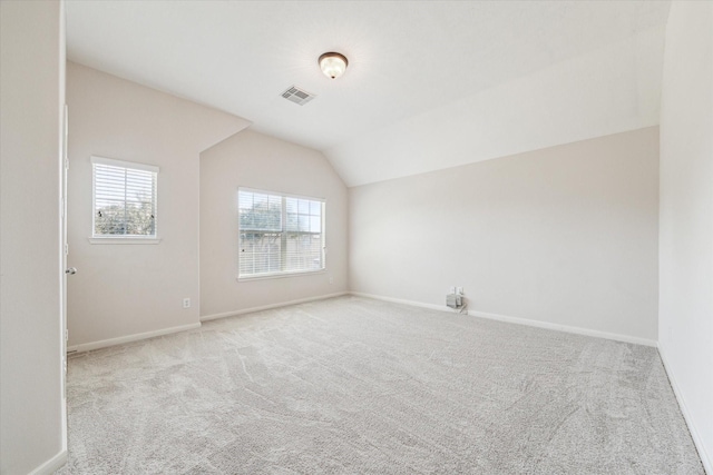 bonus room with light carpet and lofted ceiling