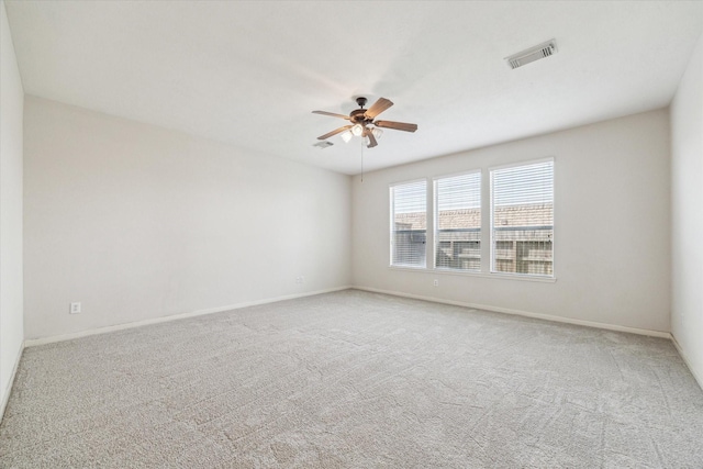 carpeted spare room with ceiling fan