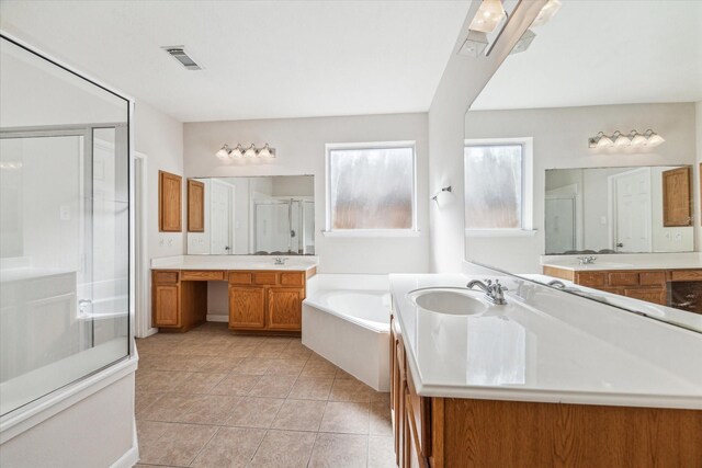 bathroom featuring plus walk in shower, vanity, and tile patterned flooring