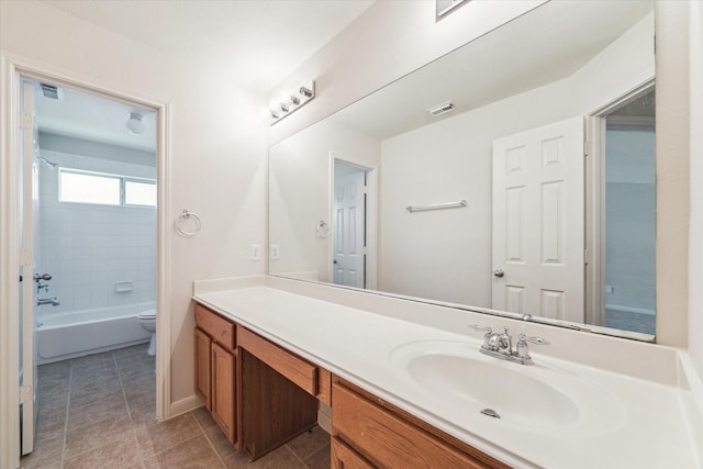 full bathroom featuring vanity, toilet, and tiled shower / bath combo