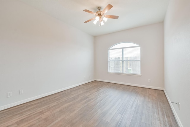 empty room featuring ceiling fan and light hardwood / wood-style flooring