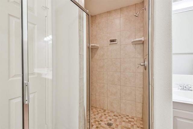 bathroom featuring sink and a shower with door