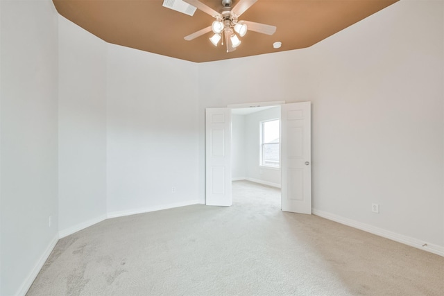 unfurnished room with ceiling fan and light colored carpet