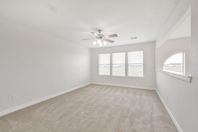 carpeted spare room featuring ceiling fan