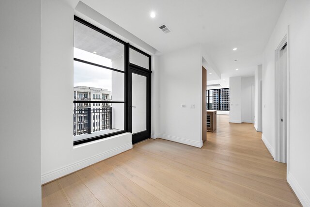 foyer entrance featuring light hardwood / wood-style flooring and floor to ceiling windows