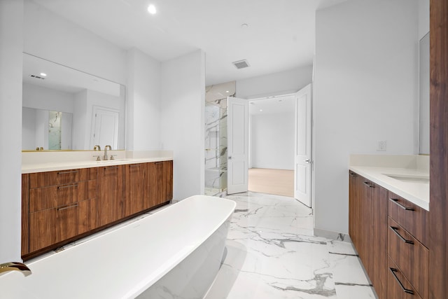 bathroom with vanity and a bath