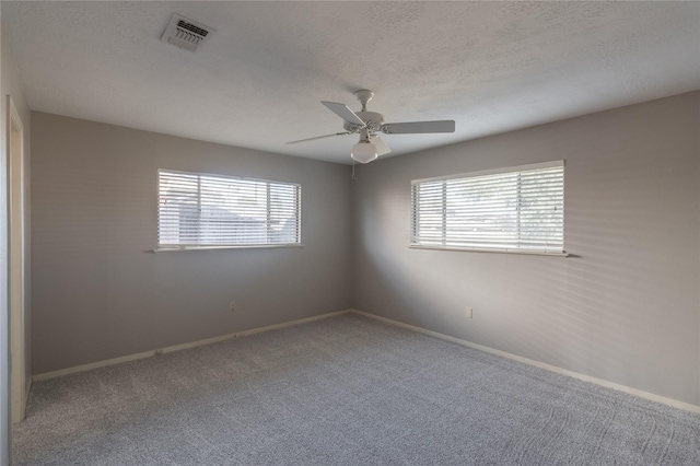 empty room featuring carpet floors and ceiling fan