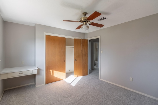 unfurnished bedroom featuring light colored carpet and ceiling fan