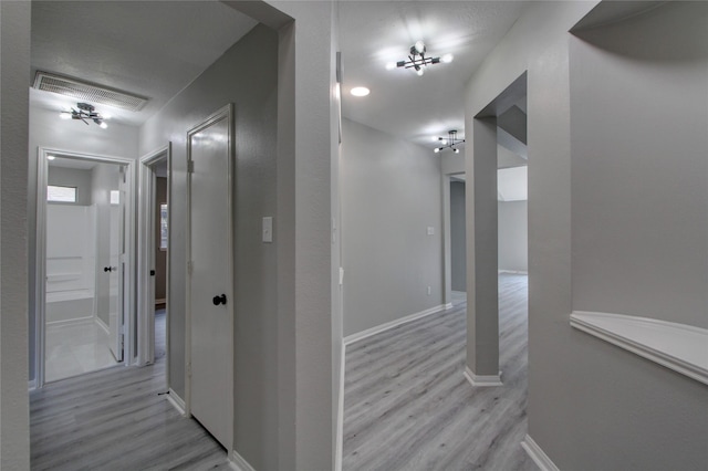 hallway with light hardwood / wood-style flooring