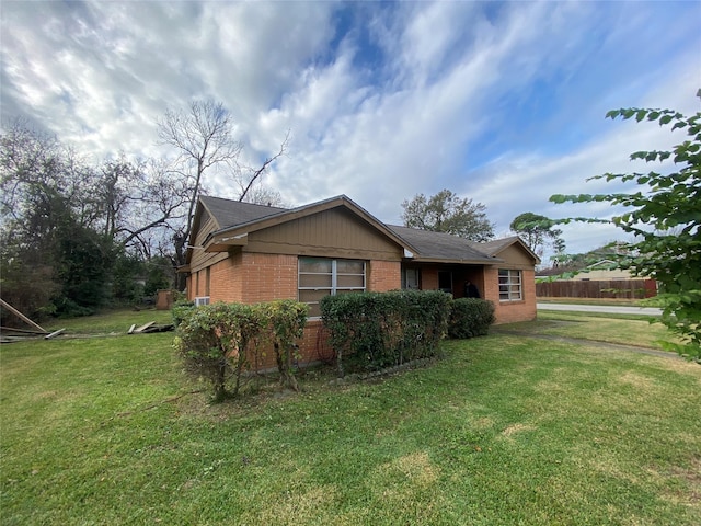 view of side of property with a lawn