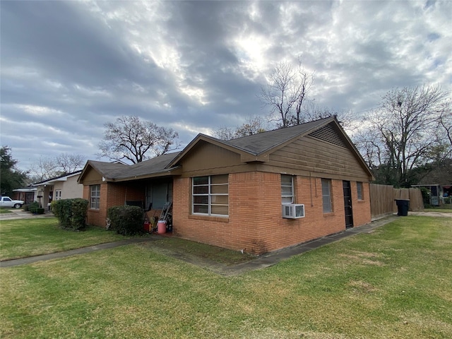 view of property exterior with a lawn and cooling unit