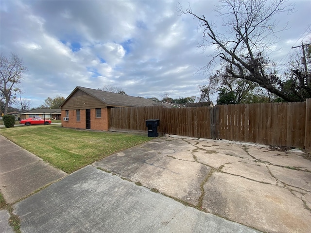 view of side of property with a yard