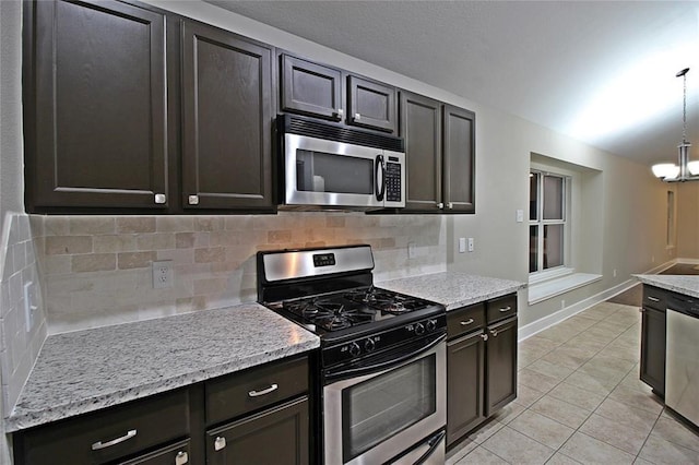 kitchen with backsplash, a chandelier, pendant lighting, light tile patterned floors, and appliances with stainless steel finishes