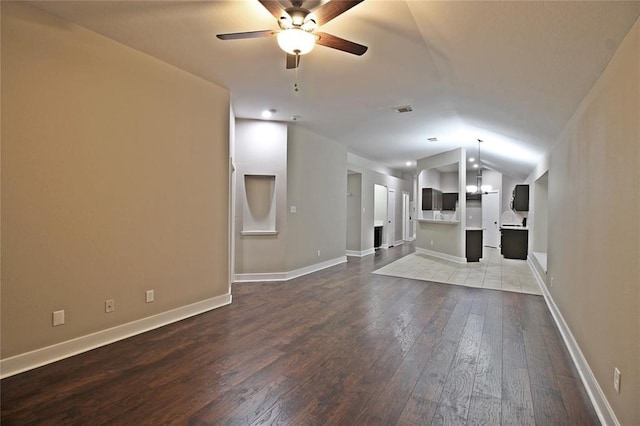 unfurnished living room featuring ceiling fan, wood-type flooring, and lofted ceiling