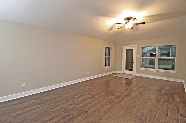 empty room featuring dark hardwood / wood-style floors, ceiling fan, and lofted ceiling