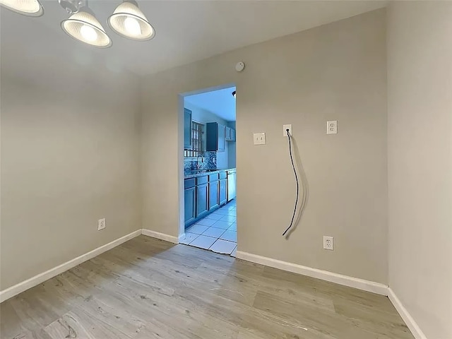 unfurnished room featuring sink and light wood-type flooring