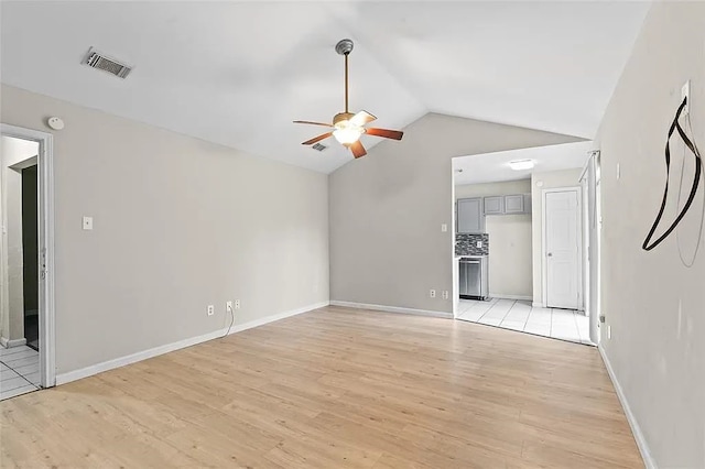 unfurnished living room with ceiling fan, lofted ceiling, and light wood-type flooring