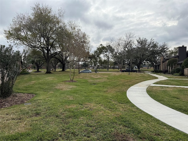 view of property's community with a lawn