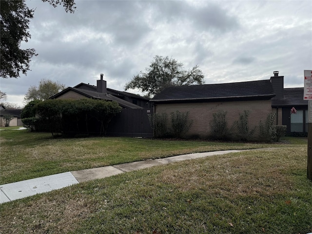 view of home's exterior with a yard