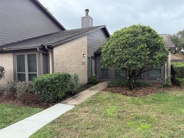 view of side of home with a lawn