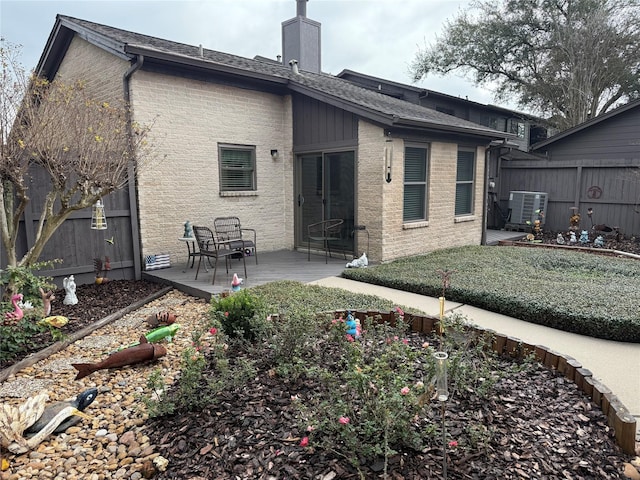 rear view of property with central air condition unit