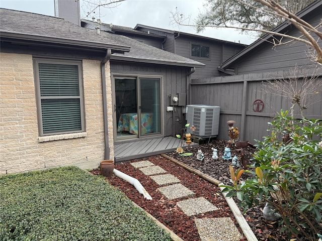 property entrance featuring central AC unit