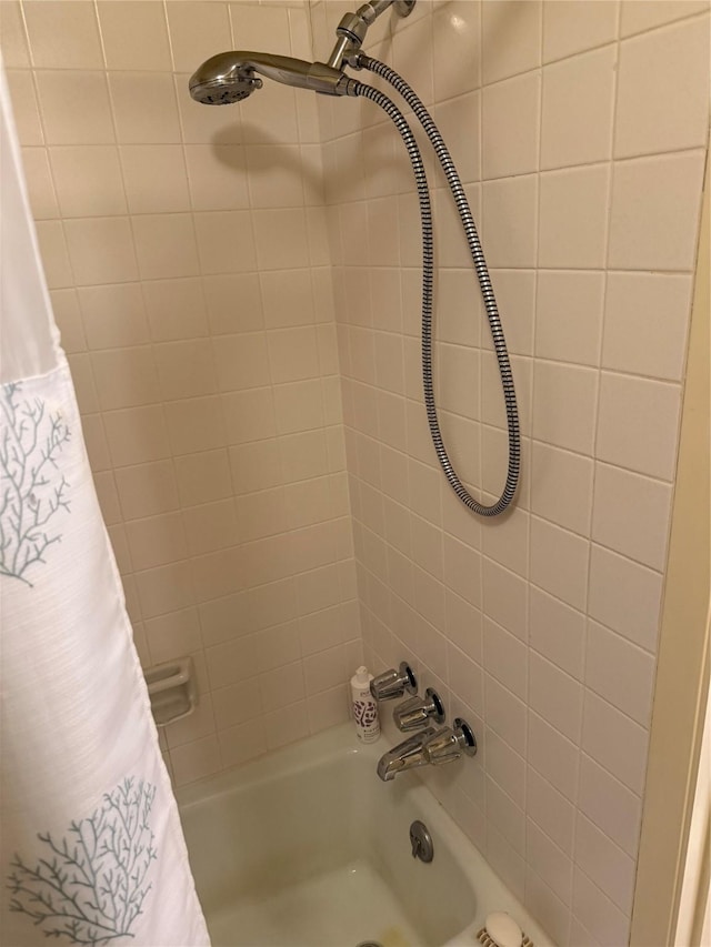 bathroom with shower / bath combo with shower curtain