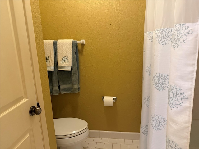 bathroom featuring tile patterned flooring and toilet