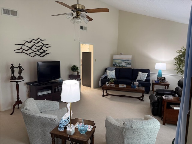 carpeted living room with high vaulted ceiling and ceiling fan