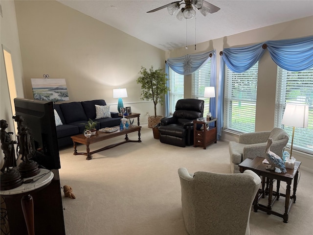 carpeted living room with ceiling fan