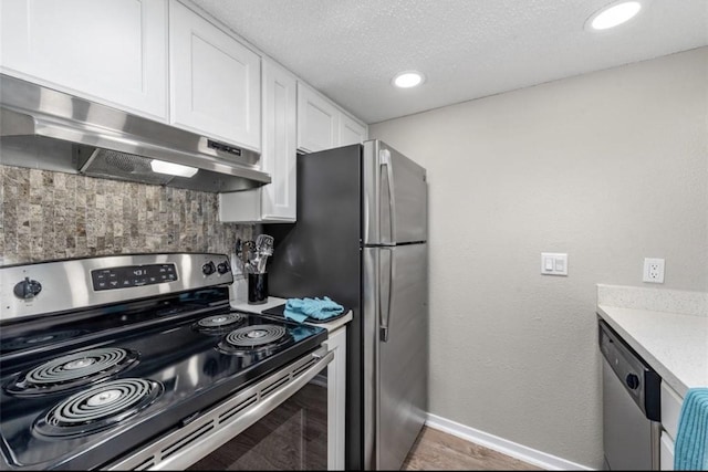 kitchen featuring decorative backsplash, a textured ceiling, white cabinets, and stainless steel appliances