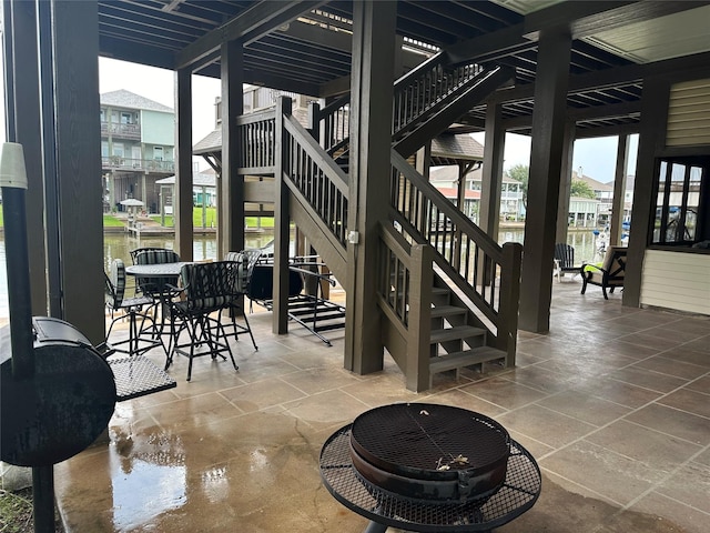 view of patio / terrace featuring a fire pit and a water view