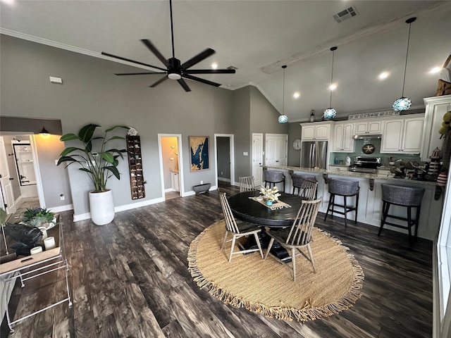 dining room with ceiling fan, crown molding, high vaulted ceiling, and dark wood-type flooring