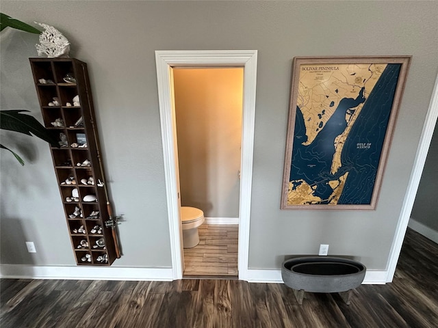 bathroom featuring wood-type flooring and toilet