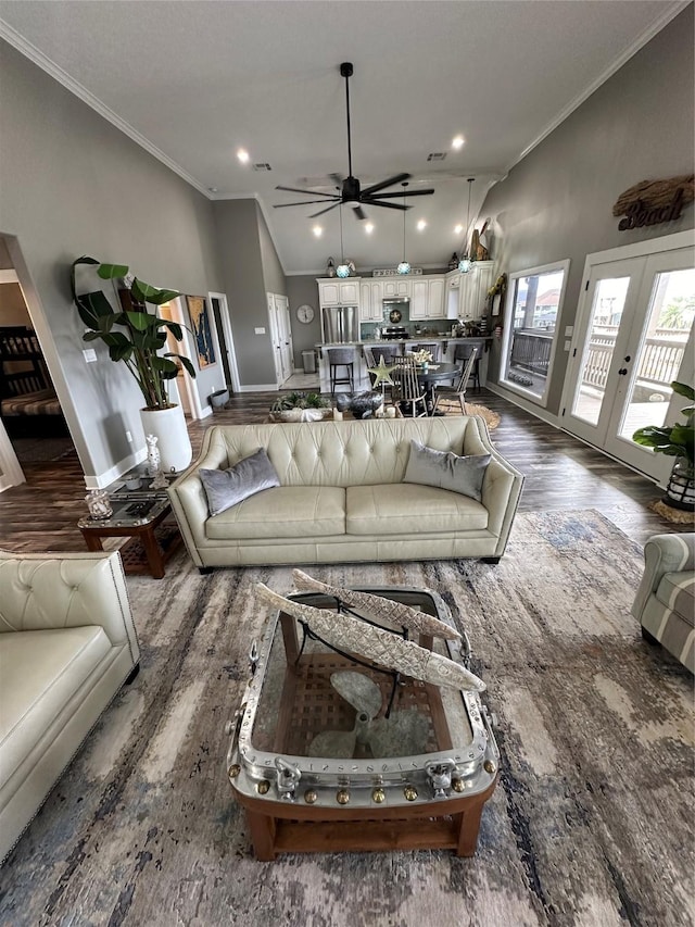 living room featuring french doors, dark hardwood / wood-style flooring, ornamental molding, vaulted ceiling, and ceiling fan