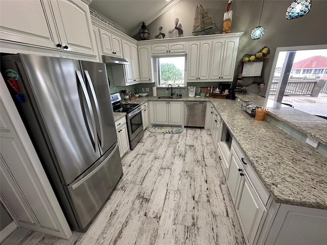 kitchen featuring sink, vaulted ceiling, decorative light fixtures, light stone counters, and stainless steel appliances