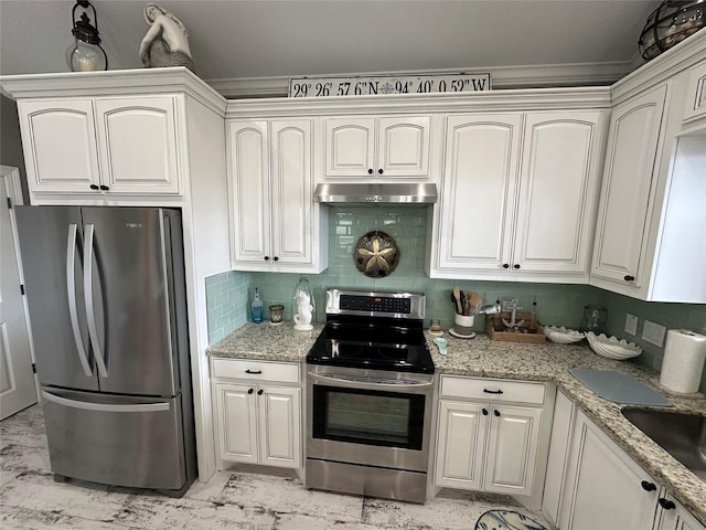 kitchen with light stone countertops, sink, backsplash, white cabinets, and appliances with stainless steel finishes