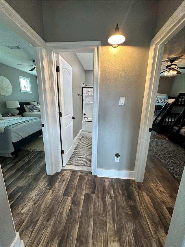 corridor featuring dark hardwood / wood-style flooring