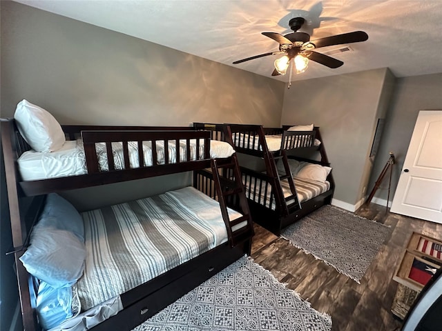 bedroom with ceiling fan and dark hardwood / wood-style floors