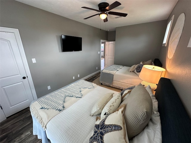 bedroom with dark hardwood / wood-style floors and ceiling fan