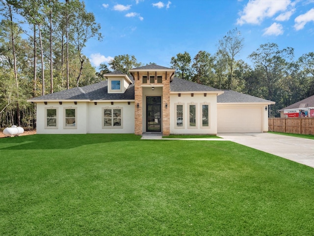 prairie-style home featuring a front yard and a garage