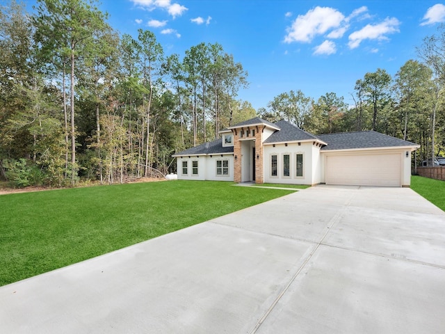 prairie-style house featuring a garage and a front lawn